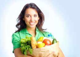 Portrait of pretty girl with big paper sack full of different fruits and vegetables